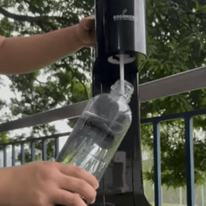 Plain water being poured into Sodarizer bottle from a pitcher