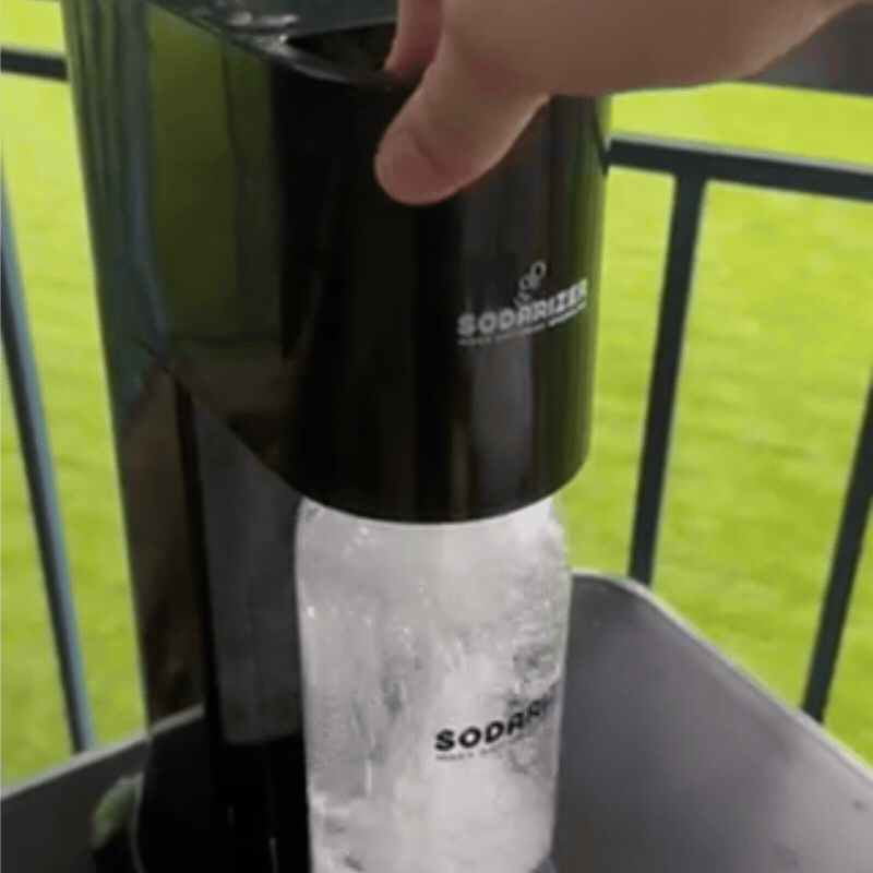 Hand pressing the STEEL lever to carbonate water